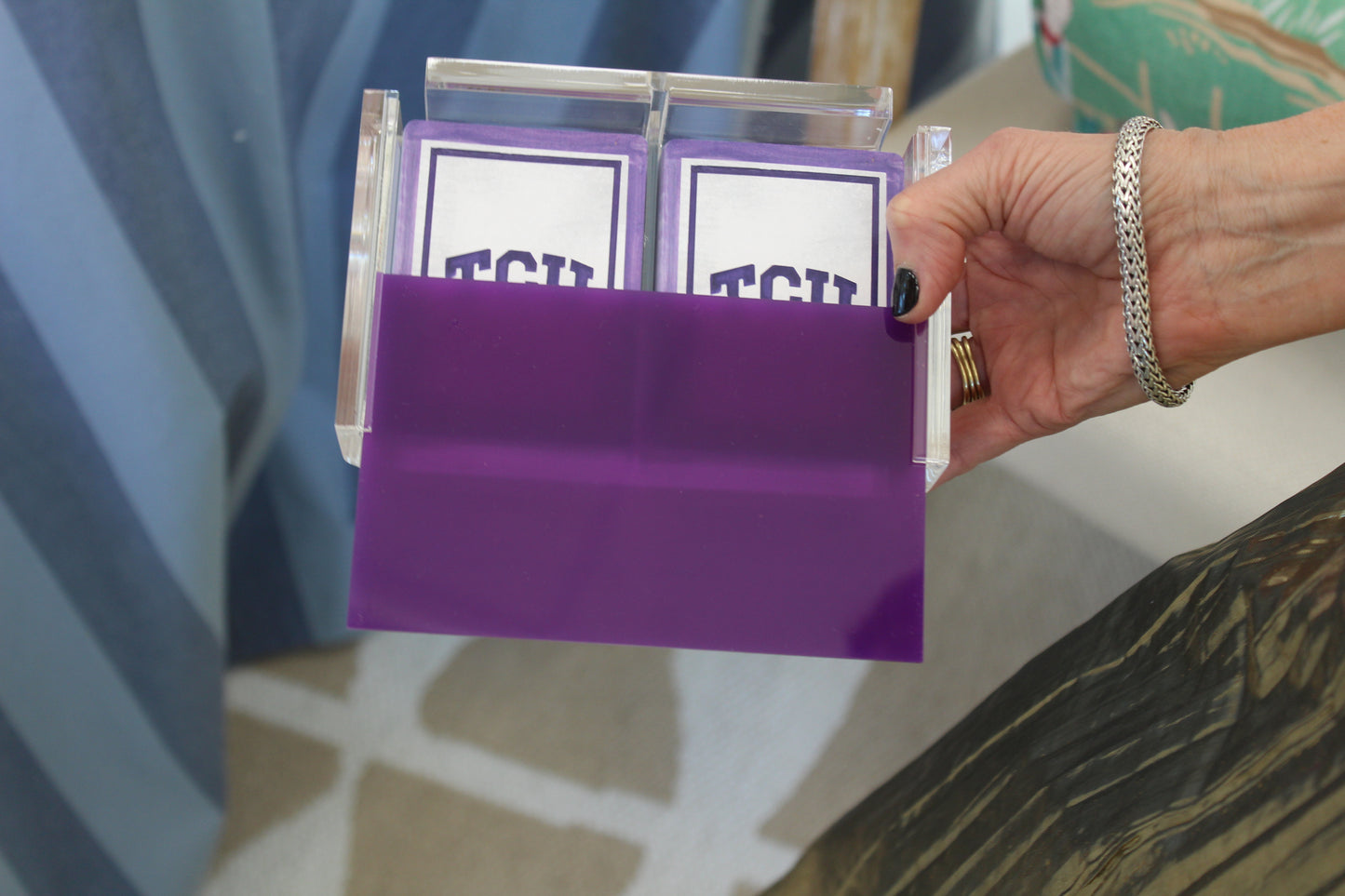 purple playing card case holding TCU playing cards