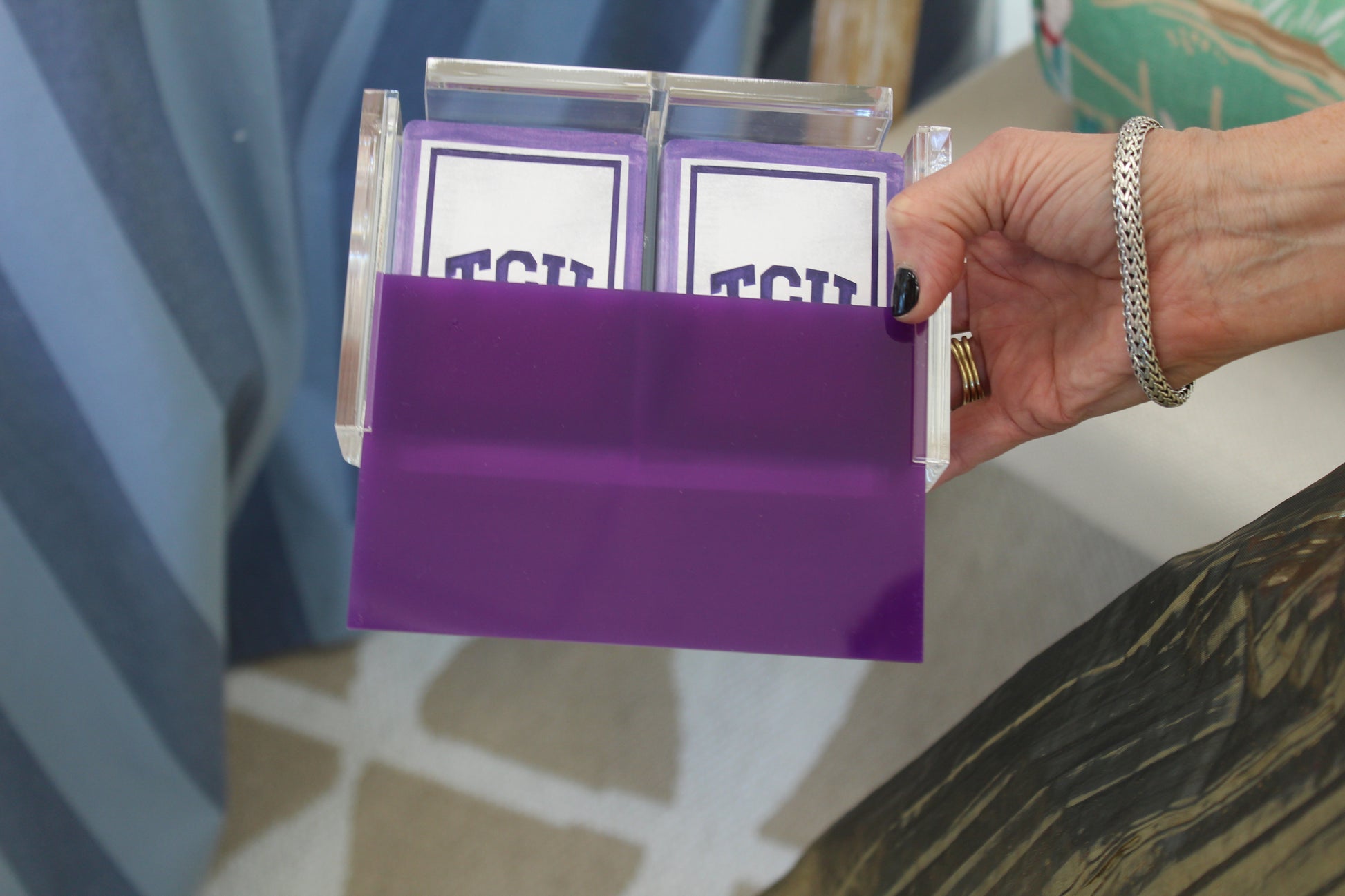 purple playing card case holding TCU playing cards